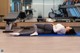 A woman laying on a yoga mat in a gym.