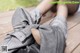 A person laying on a wooden deck with their feet up.