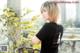 A woman in a black shirt standing on a balcony.