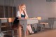 A girl sitting at a desk in a classroom.