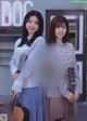 A couple of young women standing next to each other holding guitars.